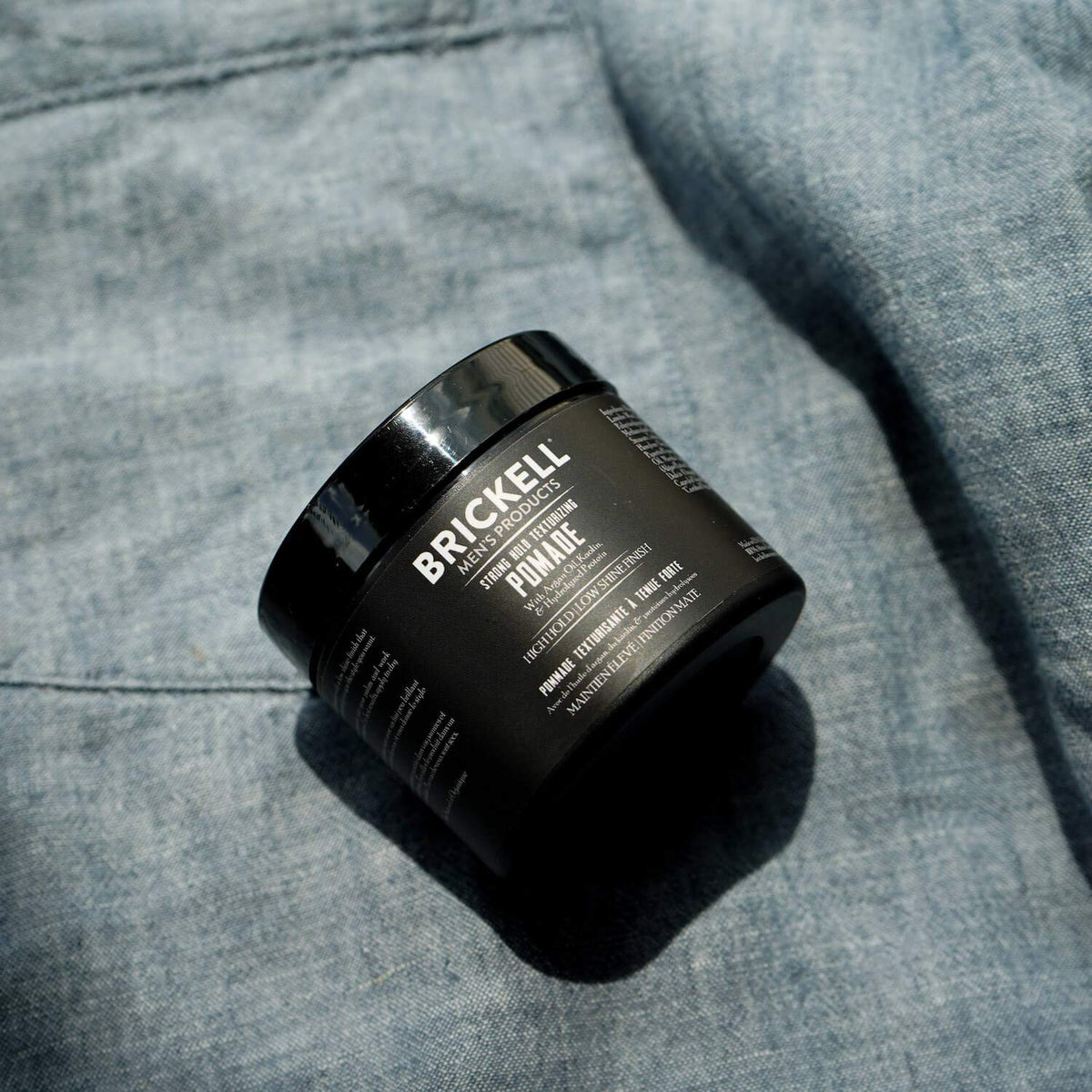 Brickell Men's Products open tin close-up revealing fiber texture and easy scoopability