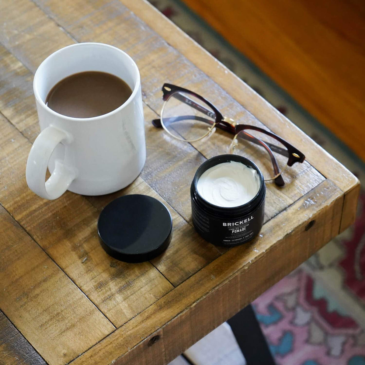 Brickell Men's Products jar on bathroom vanity indicating daily grooming convenience