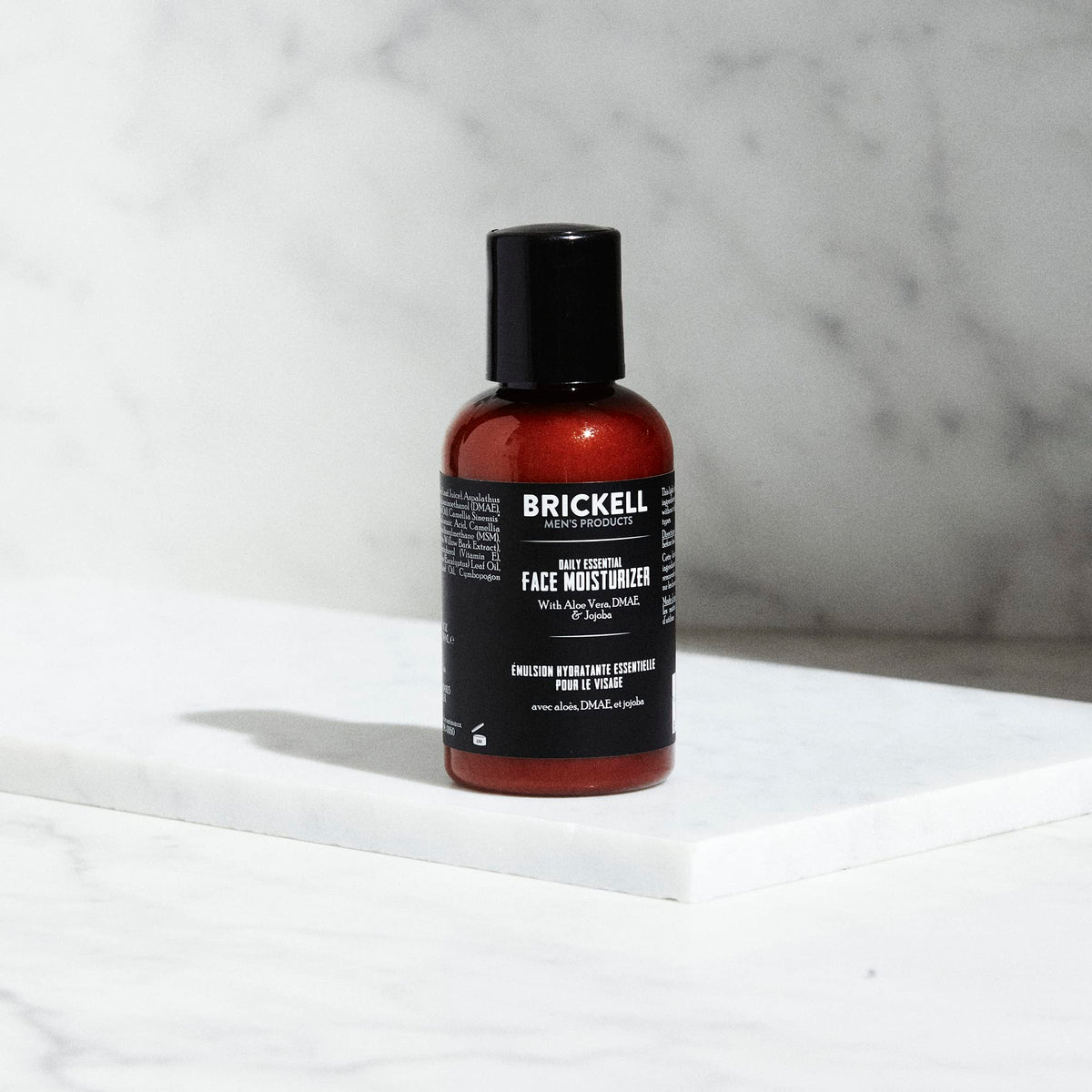 Brickell pump dispensing lotion close-up showing lightweight texture