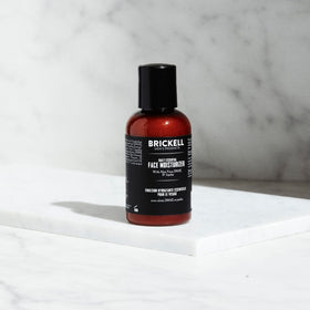 Brickell pump dispensing lotion close-up showing lightweight texture
