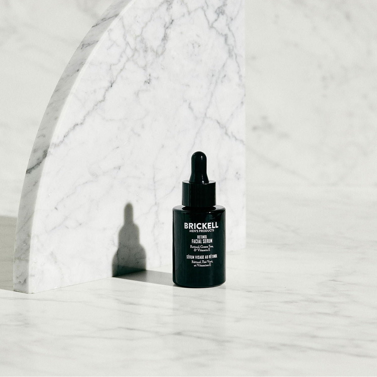 Brickell Men's Products pipette dispensing serum highlighting precise application benefit
