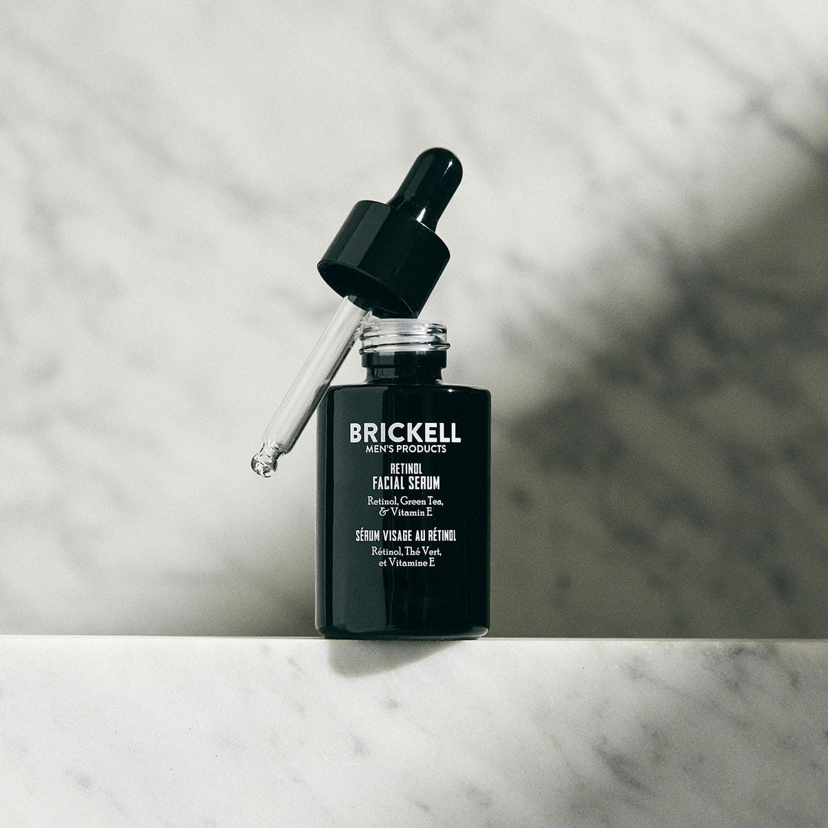 Brickell Men's Products clear serum drop on skin showing lightweight hydrating benefit