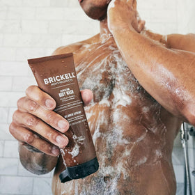 Brickell scale comparison with hand shows travel-friendly 8oz size for gym bags