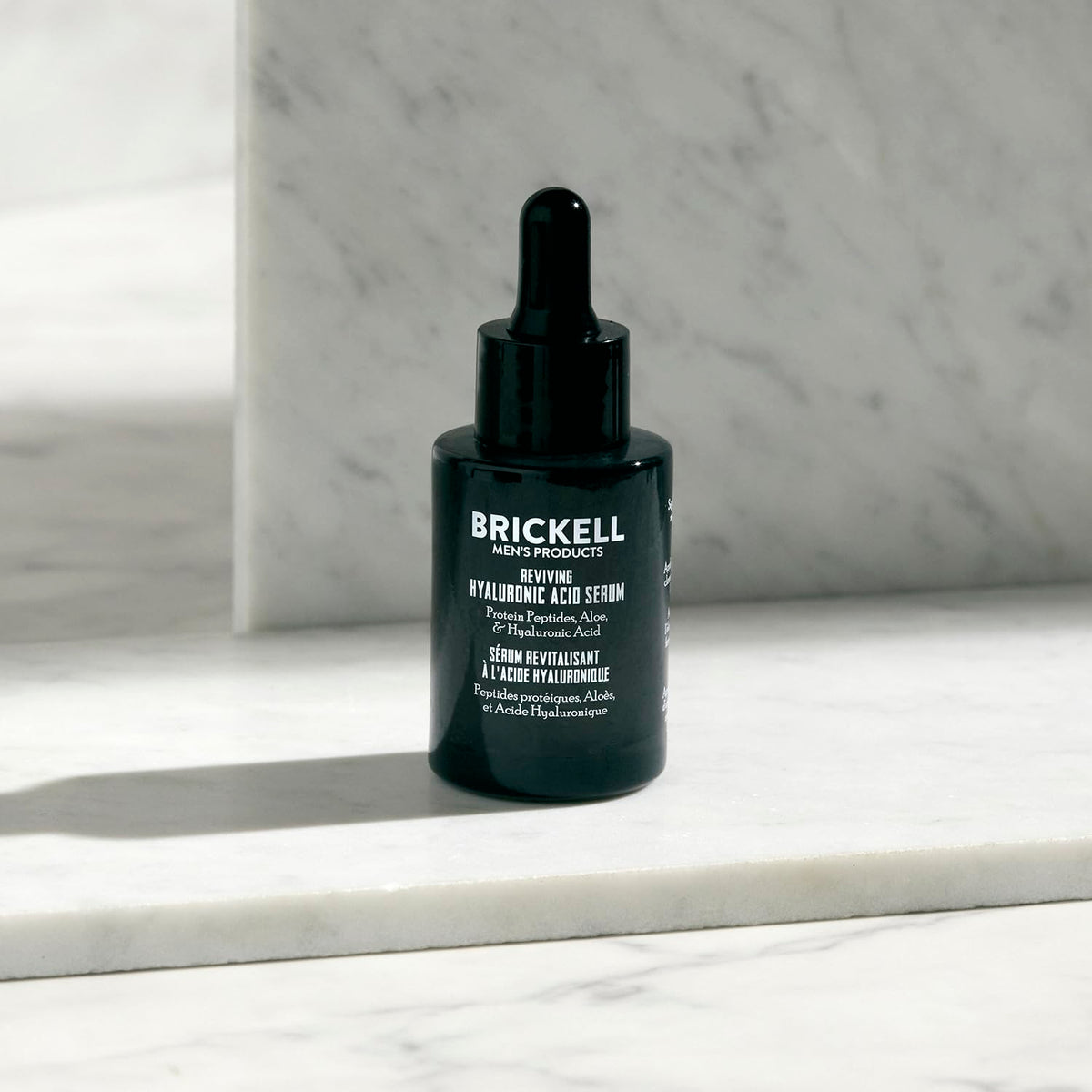 Brickell serum applied to male cheek demonstrating fast absorption and smoother feel