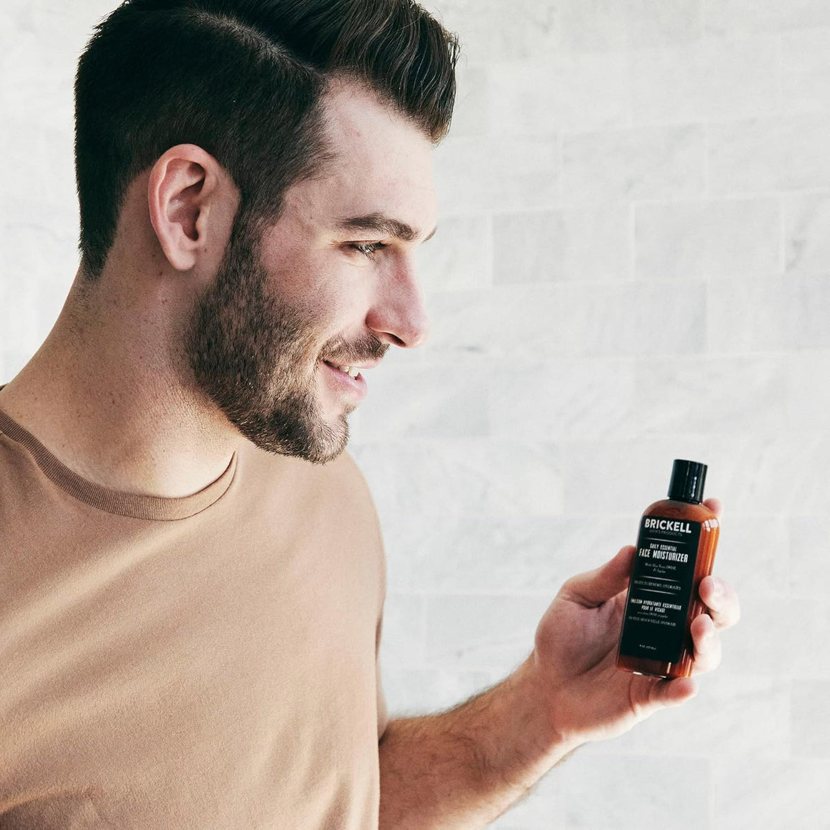 Brickell Men's Products size comparison with hand to show 4-ounce scale and travel-friendly benefit