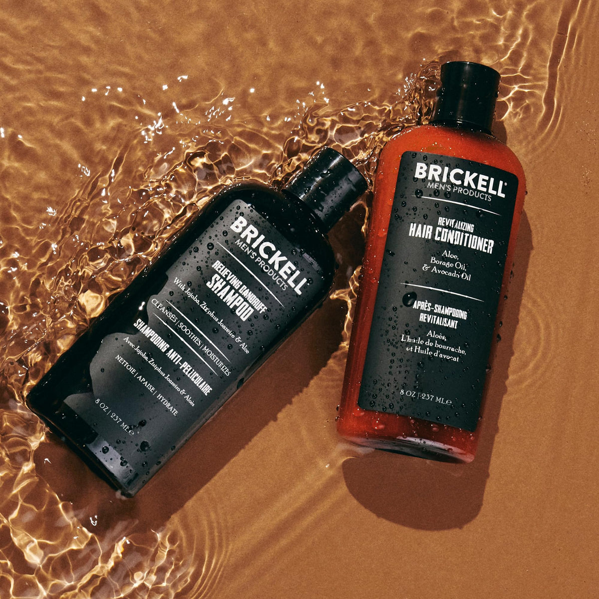 Brickell bottles held in hand for scale showing portable size and travel-friendly benefit