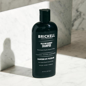 Brickell 8 oz bottle next to ruler showing scale and travel-friendly size
