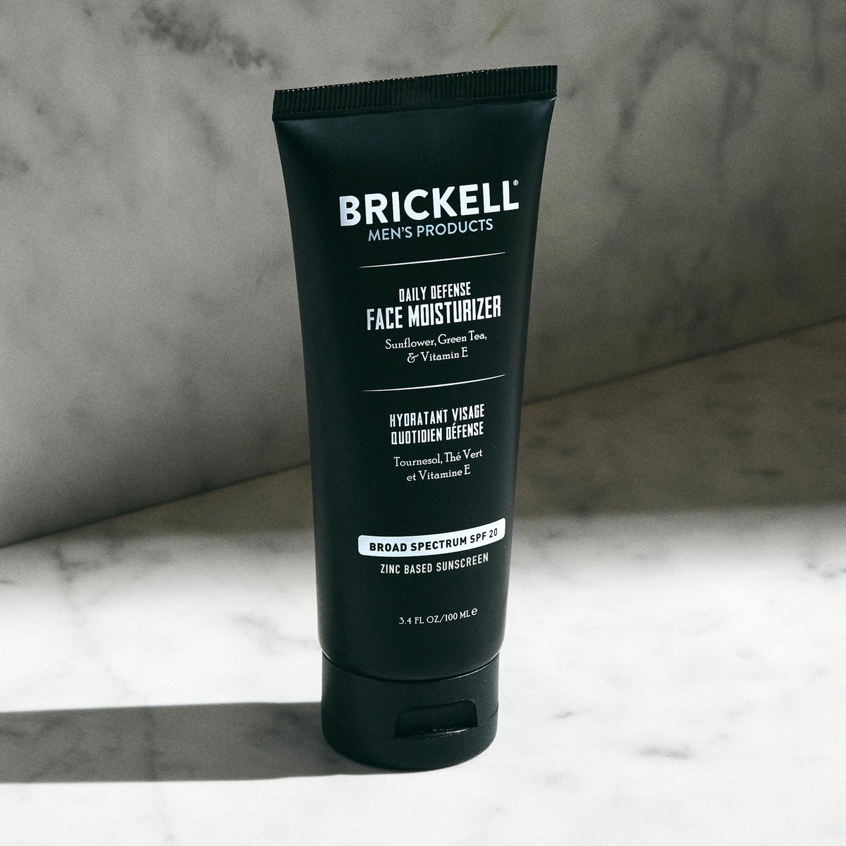 Brickell Men's Products size comparison with coin showing compact 3.4 oz travel-friendly jar