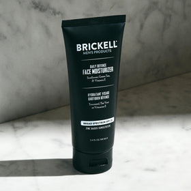Brickell Men's Products size comparison with coin showing compact 3.4 oz travel-friendly jar