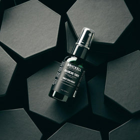 Brickell toner held in hand to show 2 ounce scale and travel-friendly benefit