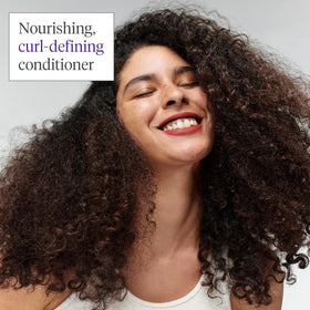Briogeo conditioner being applied to wet hair demonstrating detangling