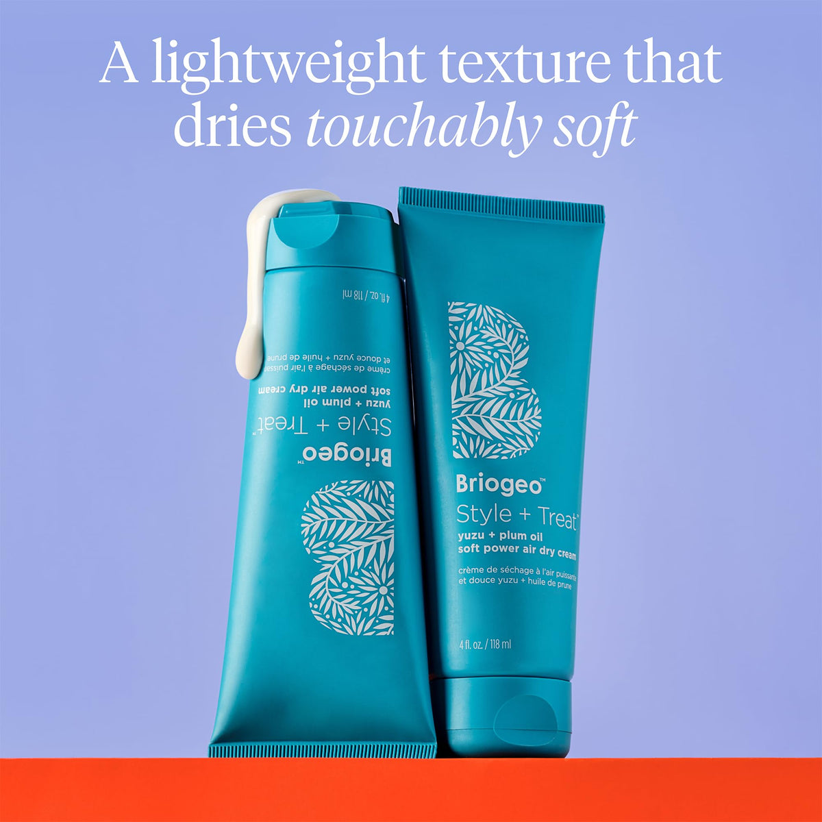 briogeo applying cream to damp wavy hair for frizz control