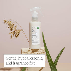 Briogeo bottle beside aloe and oat milk illustrating soothing ingredients