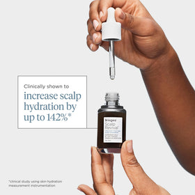 Briogeo one ounce bottle held in hand conveying compact travel-friendly size
