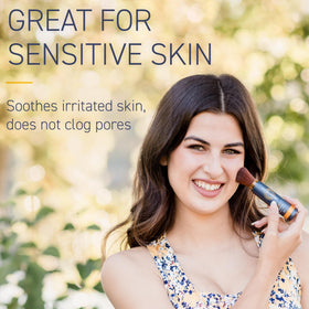 Person applying Brush On Block outdoors emphasizing quick reapplication and water-resistant protection