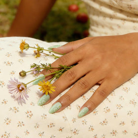BTArtbox nails held in hand to show short almond length and comfortable everyday scale