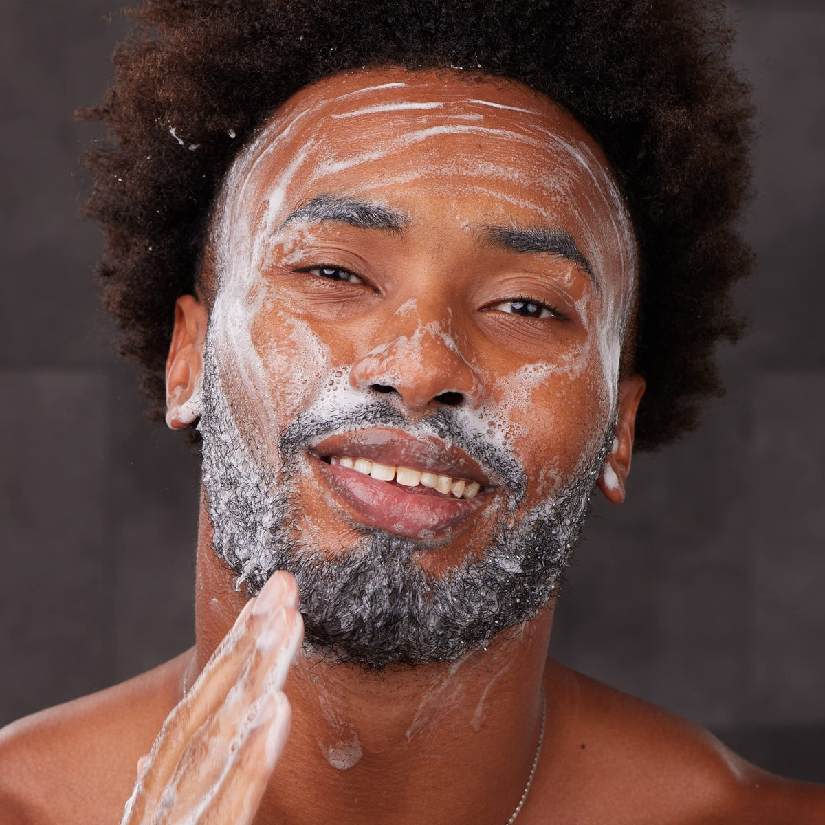 Bulldog Skincare for Men held in hand showing compact size and portability