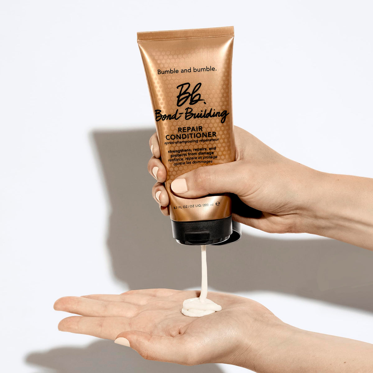 Bumble and bumble being applied to wet hair for easy detangling