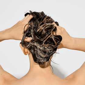 Bumble and bumble shampoo lather texture demonstrating gentle cleansing