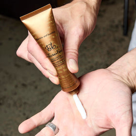 bumble and bumble tube in hand showing 2 fl oz size and travel-friendly convenience