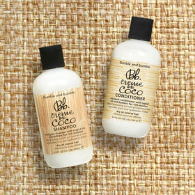 Bumble and bumble bottle in shower scene illustrating use and moisturizing benefit