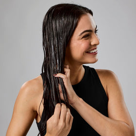 Bumble and bumble application on damp hair demonstrating frizz control and manageability