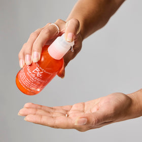 Bumble and bumble oil pouring on hand demonstrating easy dose control