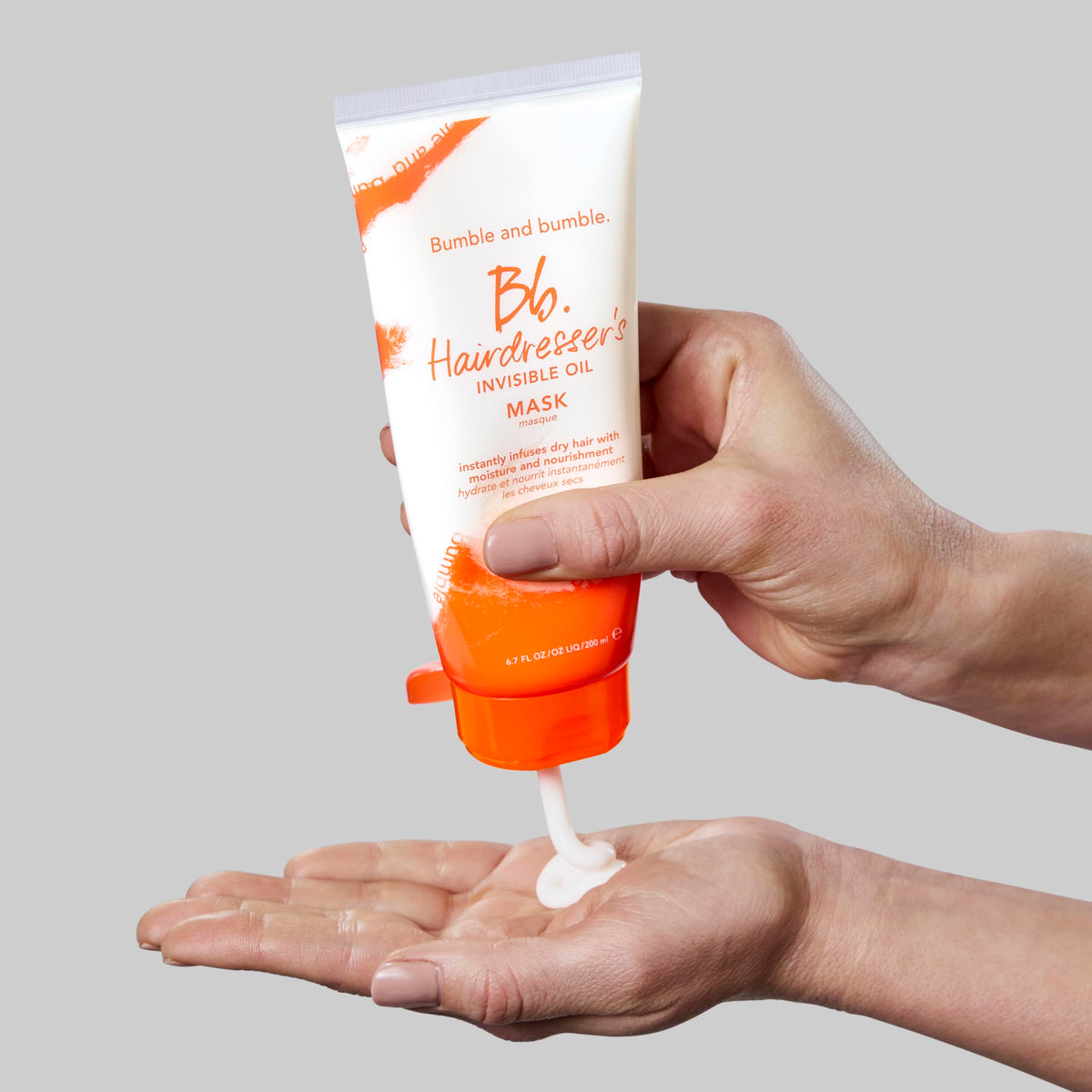 Bumble and bumble applying mask to towel-dried hair for deep conditioning
