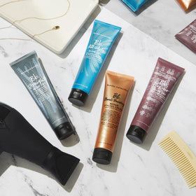 bumble and bumble on vanity with brush and towel, suggests polished salon-style results