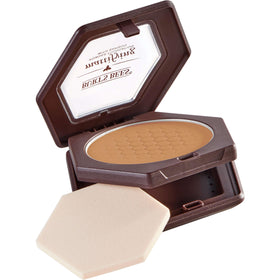 Burt's Bees compact in handbag suggesting on-the-go matte control