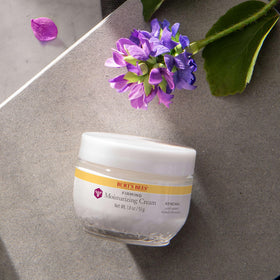 Close-up of Burt's Bees jar label showing ingredients and natural-origin claim