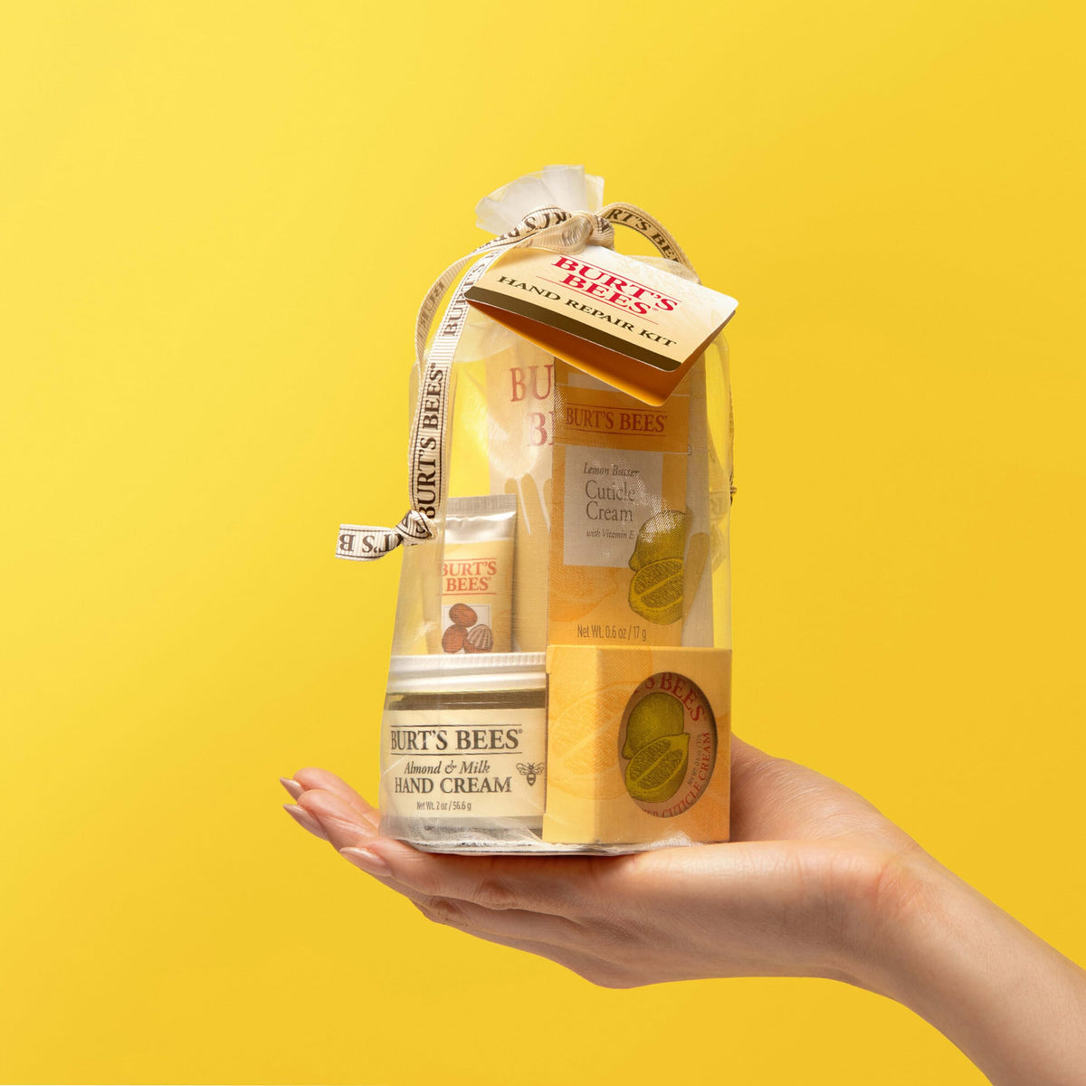 Burt's Bees lifestyle image of hands applying cream with cotton gloves demonstrating deeper conditioning benefit