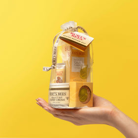 Burt's Bees lifestyle image of hands applying cream with cotton gloves demonstrating deeper conditioning benefit