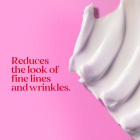 Model applying Burt's Bees cream to cheek illustrating natural routine use