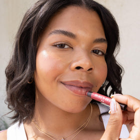 Burt's Bees shea and cocoa butter ingredients beside product for nourishment