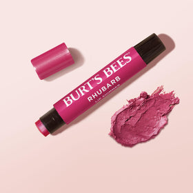 Burt's Bees lip tint inside a handbag lifestyle shot showing on-the-go convenience