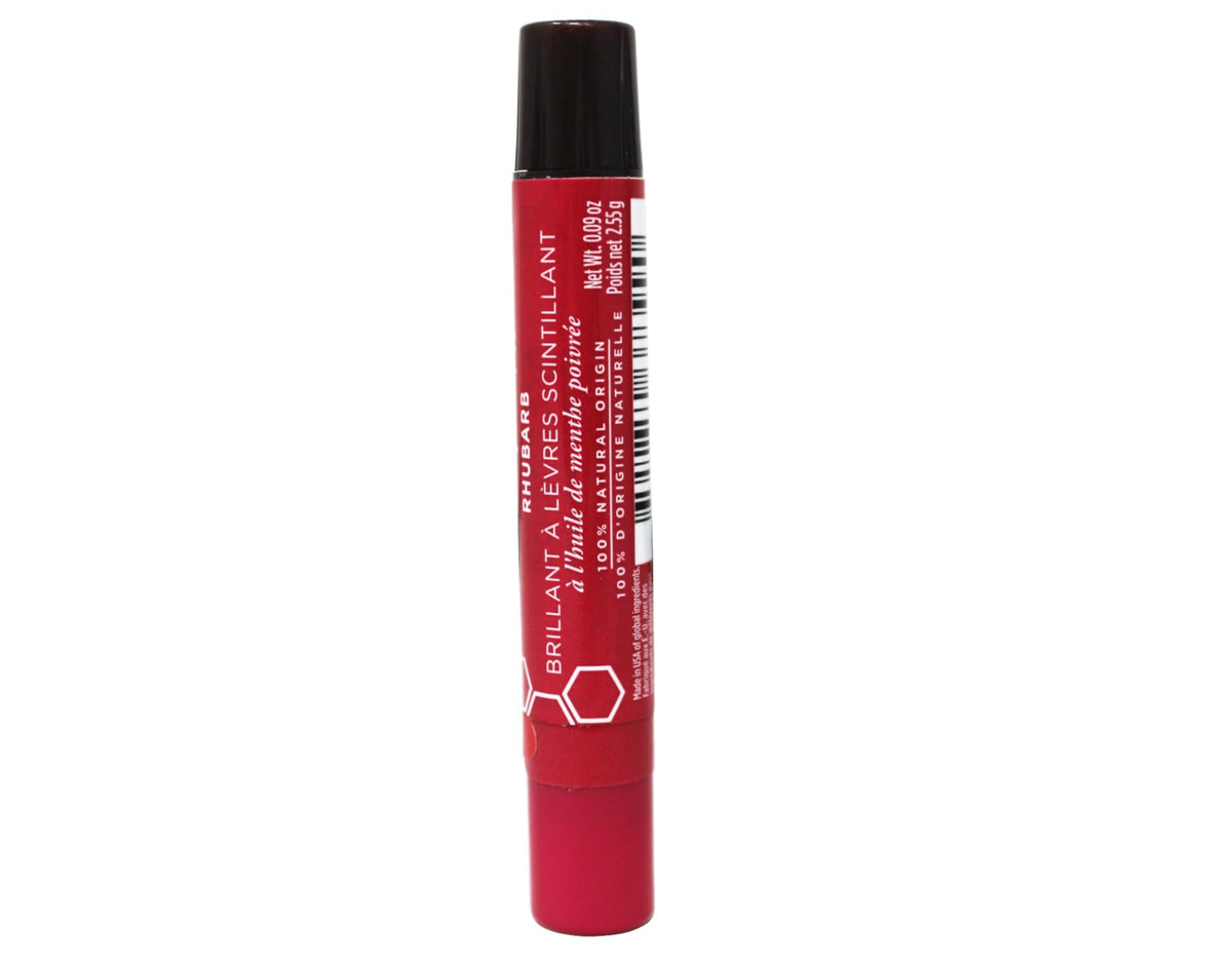 Burt's Bees rhubarb next to a coin showing compact 0.09 oz travel-friendly size