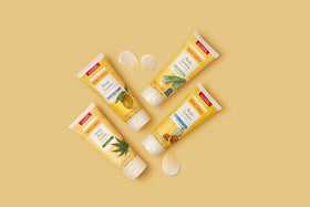 Burt's Bees 6 oz bottle held in hand showing compact travel-friendly size