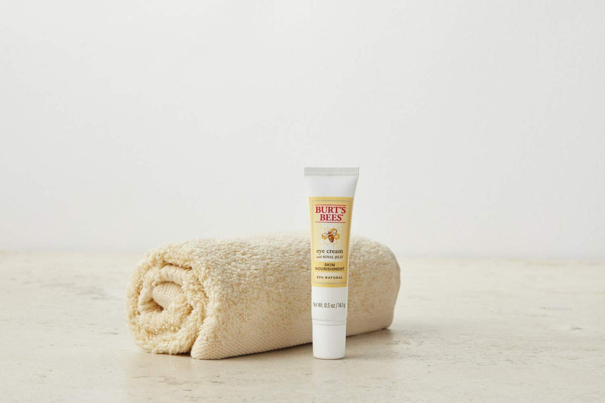 Burt's Bees product next to coin to show compact 0.5 oz size