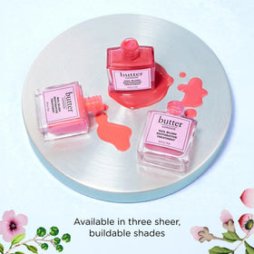 butter LONDON hand holding bottle for size comparison and easy at-home use benefit