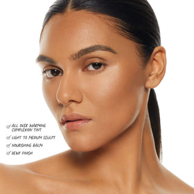 BY MARIO applying balm to cheek demonstrating easy sculpting benefit