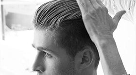 BYRD matte pomade held in hand to show compact 1.5 oz size