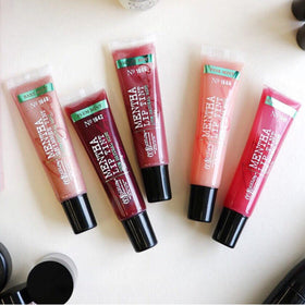 C.O. Bigelow lip tint on a desk beside a cup, showing fresh, convenient touch-ups