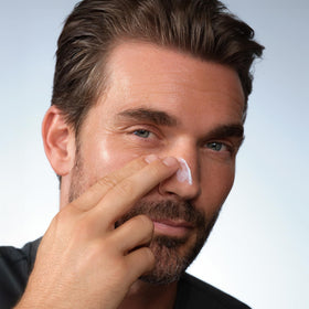 Caldera + Lab applying sunscreen to cheek demonstrating no-white-cast finish