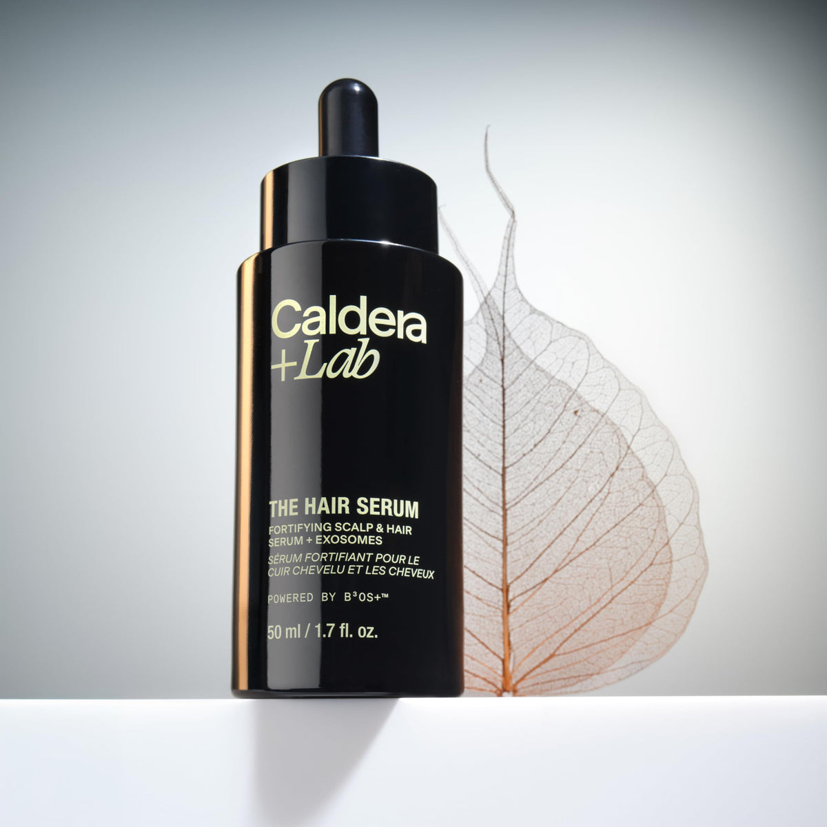 Caldera + Lab applying serum to scalp in use benefit: promotes fuller looking hair