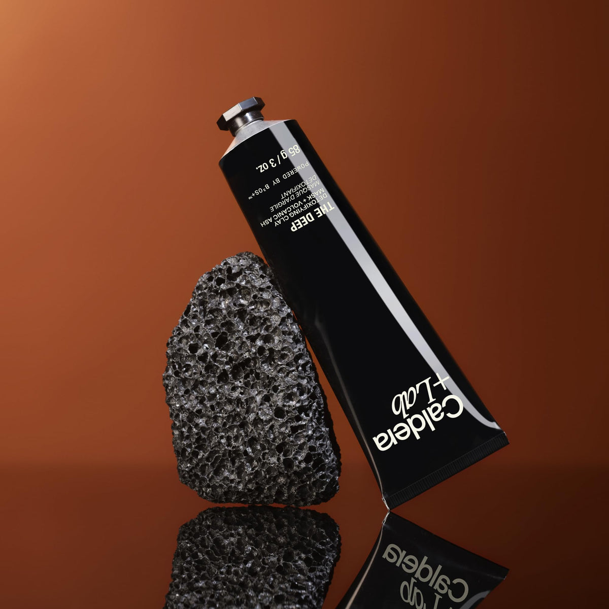 Caldera + Lab jar beside hand showing size and ease-of-use benefit
