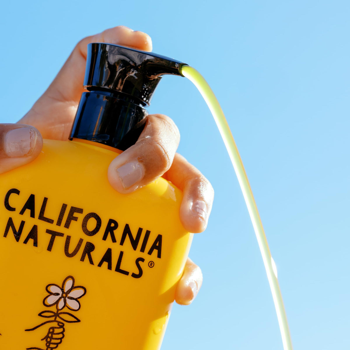 California Naturals hand holding bottle in shower showing easy use benefit