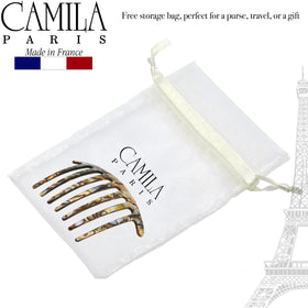 Camila Paris next to a ruler to show the 4-inch size for travel convenience