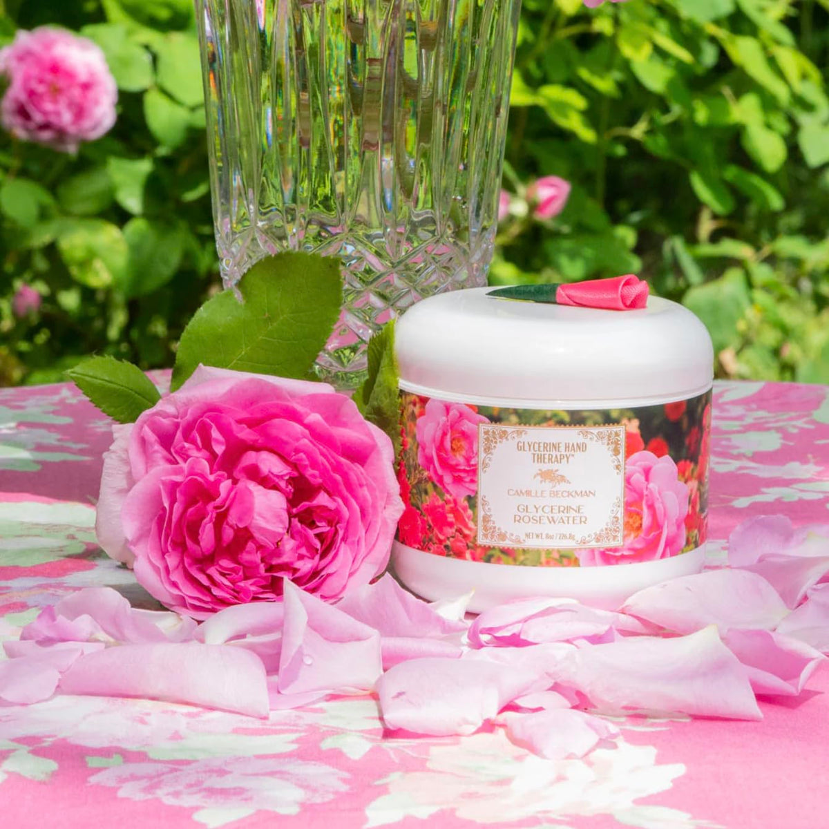 Camille Beckman open jar with rose petals showing the delicate rose tea fragrance benefit
