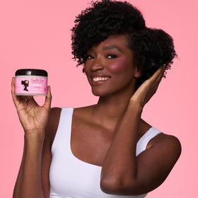 Camille Rose applying leave-in to damp hair for improved detangling